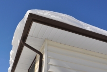corner of roof covered with snow after a storm