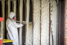 Technician adding spray foam insulation