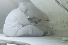 worker installing spray foam insulation